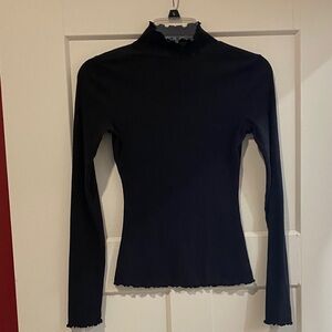 Elegant black high neck ruffle hem top